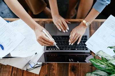 two woman looking at a computer going over a content strategy